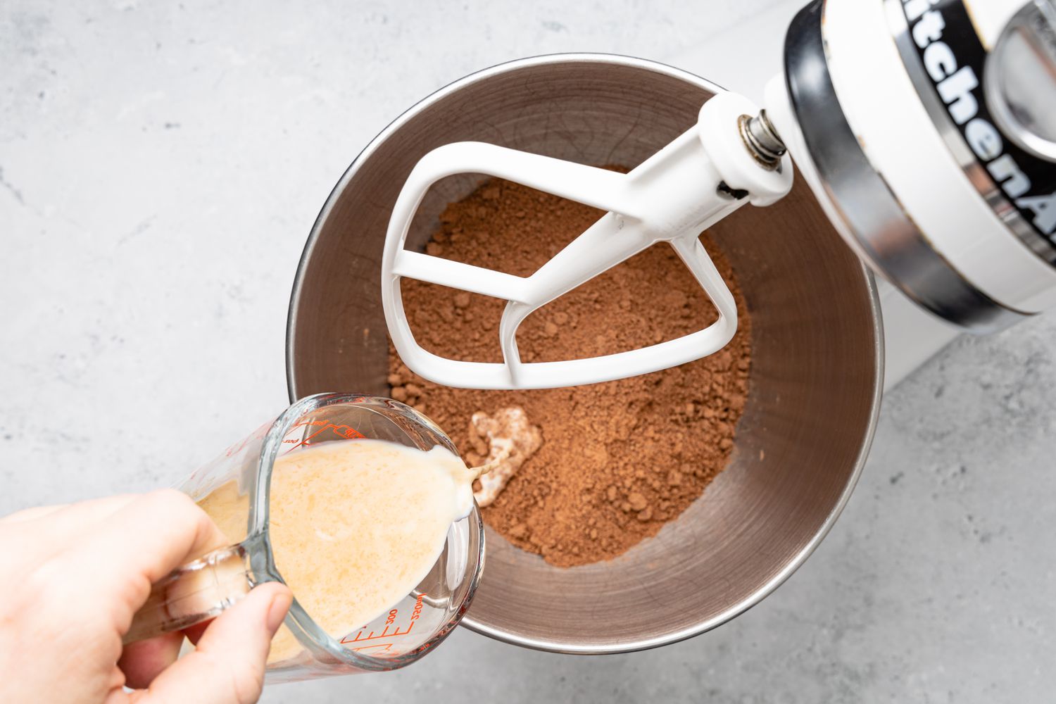 Milk-Vanilla Mixture Poured into Mixer Bowl for Chocolate Buttercream Frosting Recipe