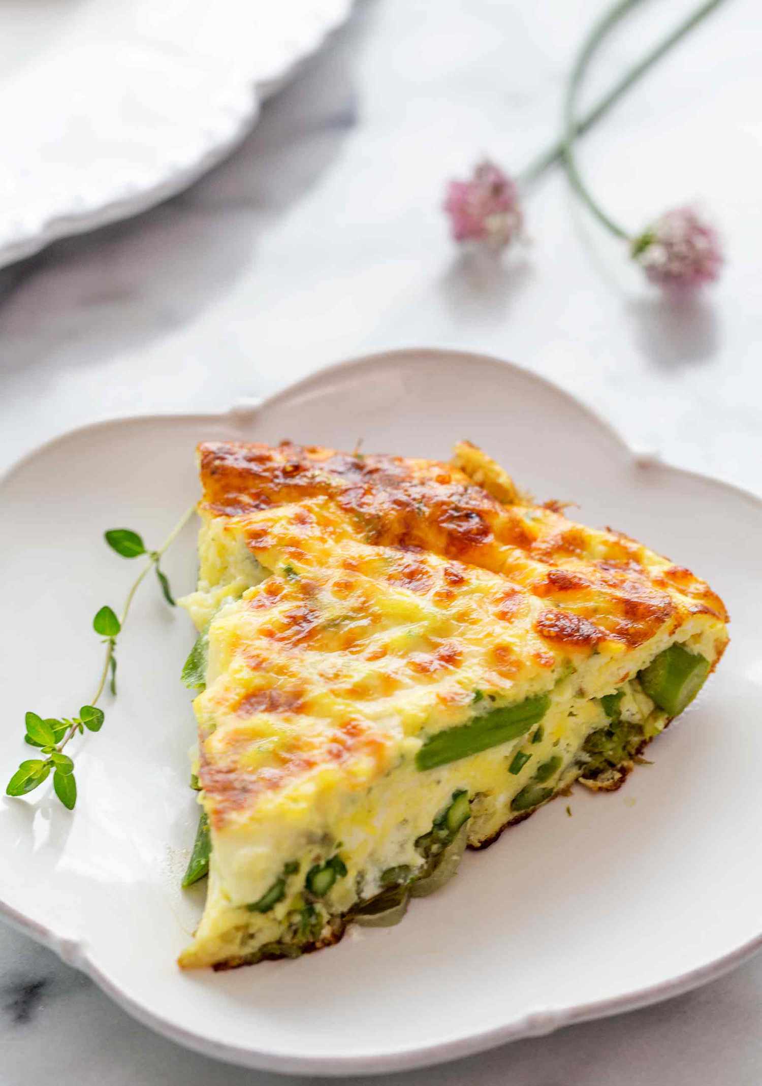 A slice of Asparagus Frittata on a white plate