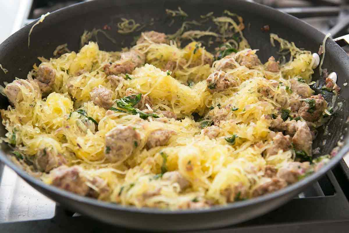 spaghetti squash added to the skillet with sausage