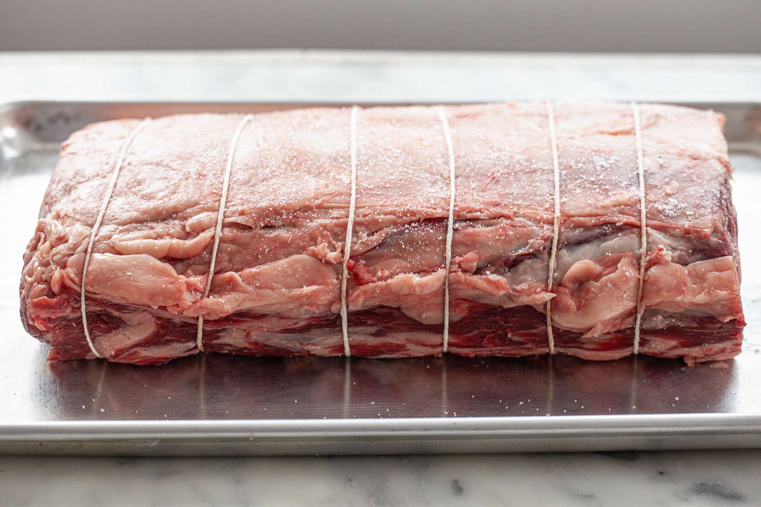 A prime rib tired and ready to be baked to make Herb butter prime rib with gravy.