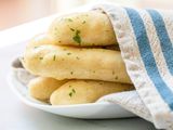 Breadsticks with Garlic Butter on a Plate Covered with a Kitchen Towel