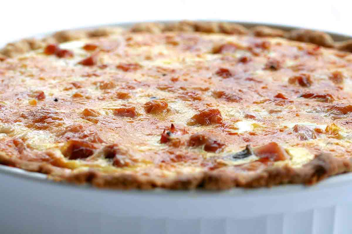 Ham and Asparagus Quiche in a white baking dish