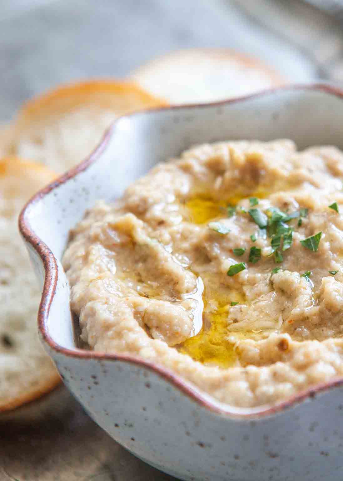 Baba ganoush eggplant dip in a shallow bowl garnished with chives