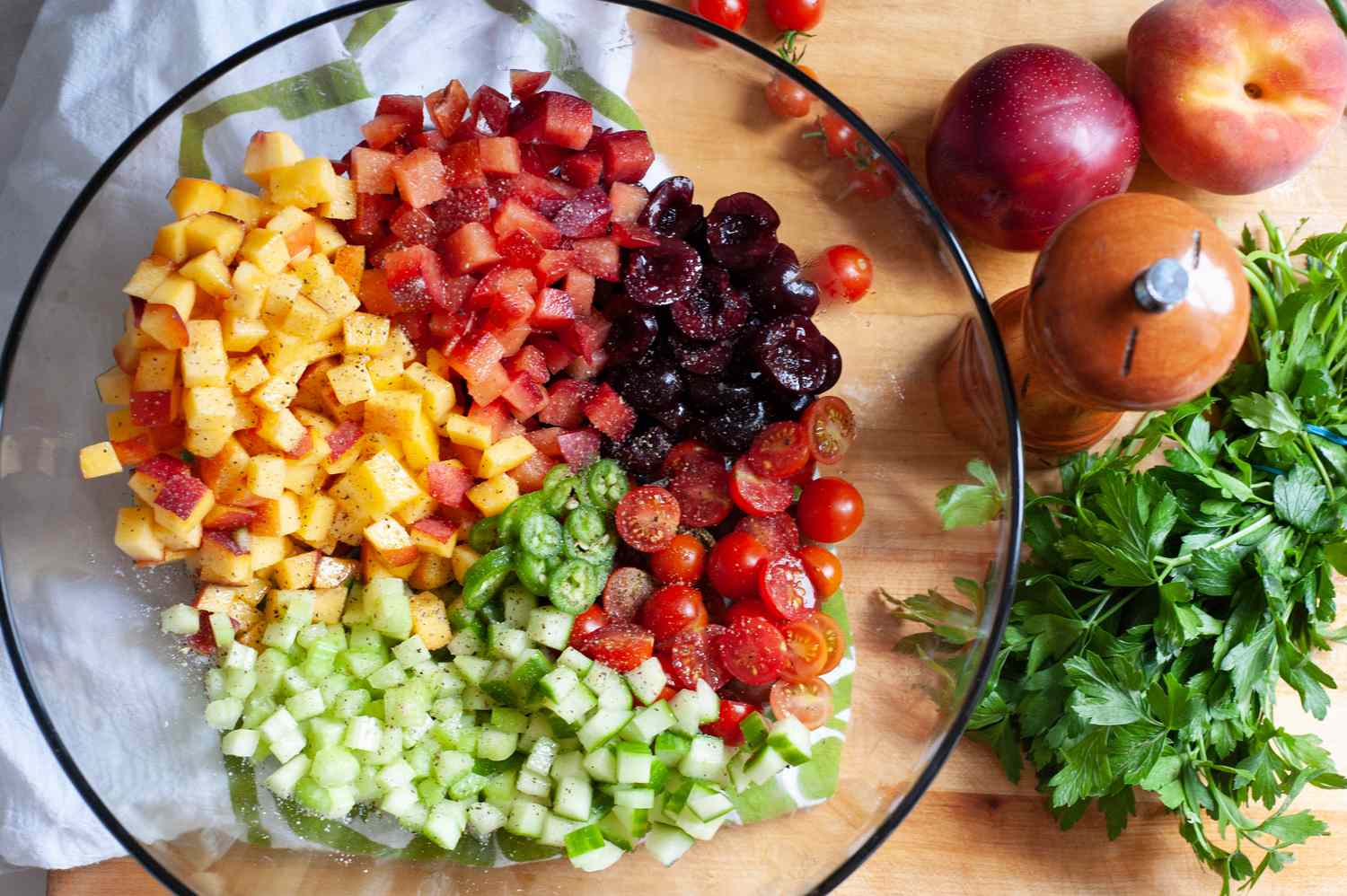 Diced ingredients in a bowl to make an herby fruit salad.