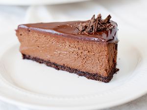 Chocolate cheesecake slice on a white plate