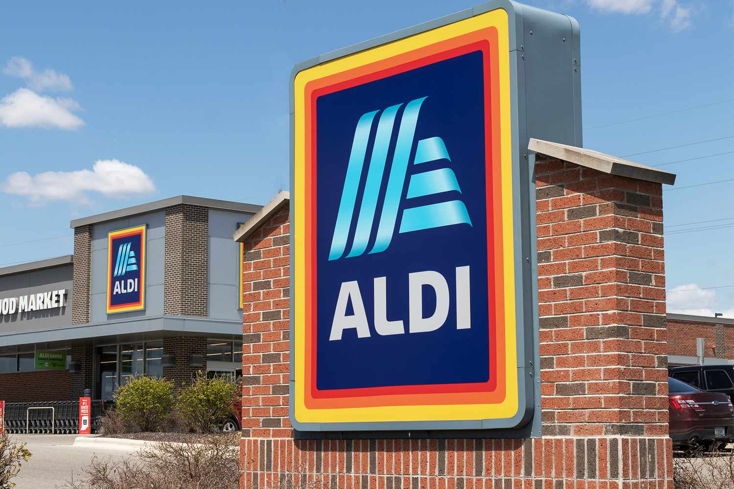Aldi store with prominent logo sign and building in the background