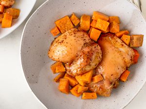 Overhead view of a bowl of roast chicken and cubed sweet potatoes