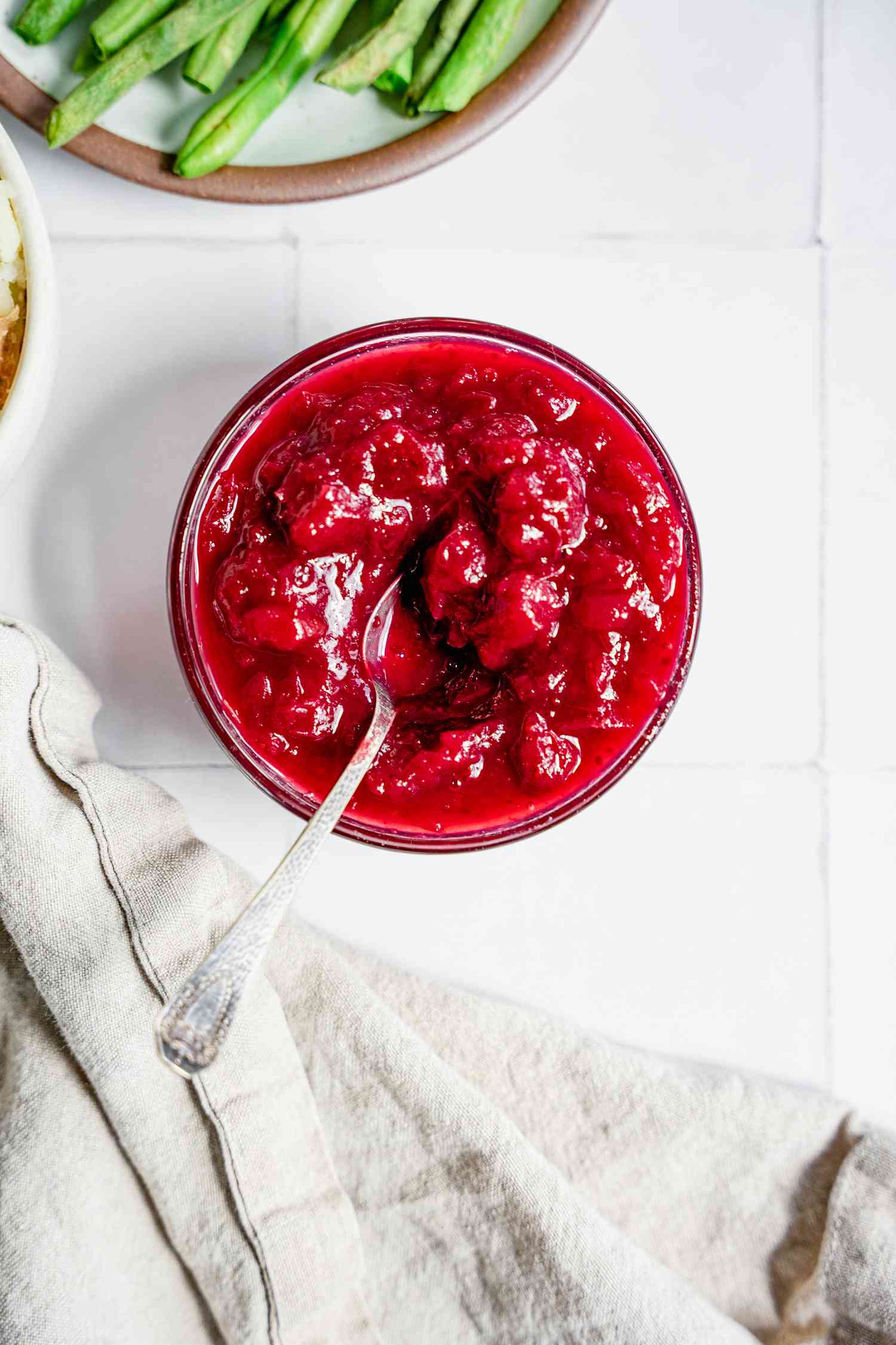 Instant Pot Cranberry Sauce Next to a Bowl of Green Beans