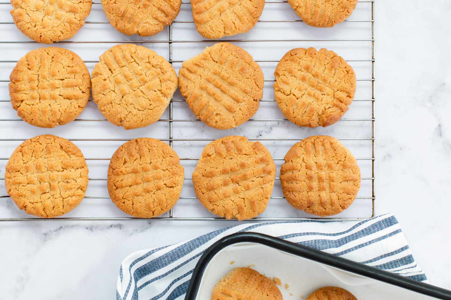 Baked Peanut Butter Cookies cooling on a rack.
