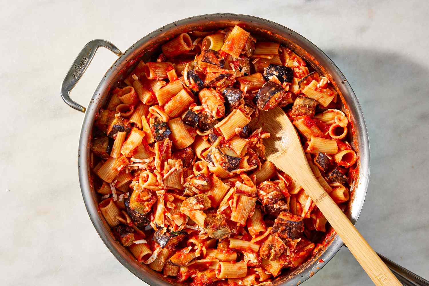 cooked eggplant pieces mixed into pasta in the pot for pasta alla norma recipe 