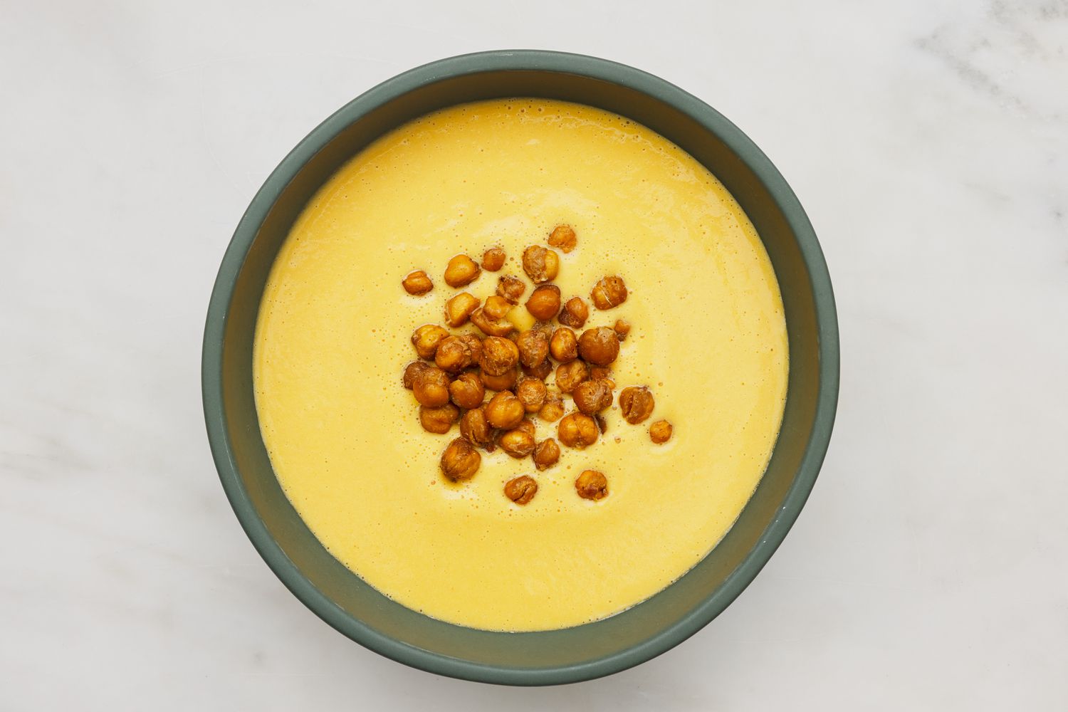 Bowl of hummus soup topped with roasted chickpeas