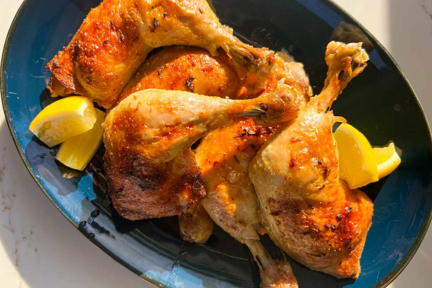 Whole chicken legs on a blue platter