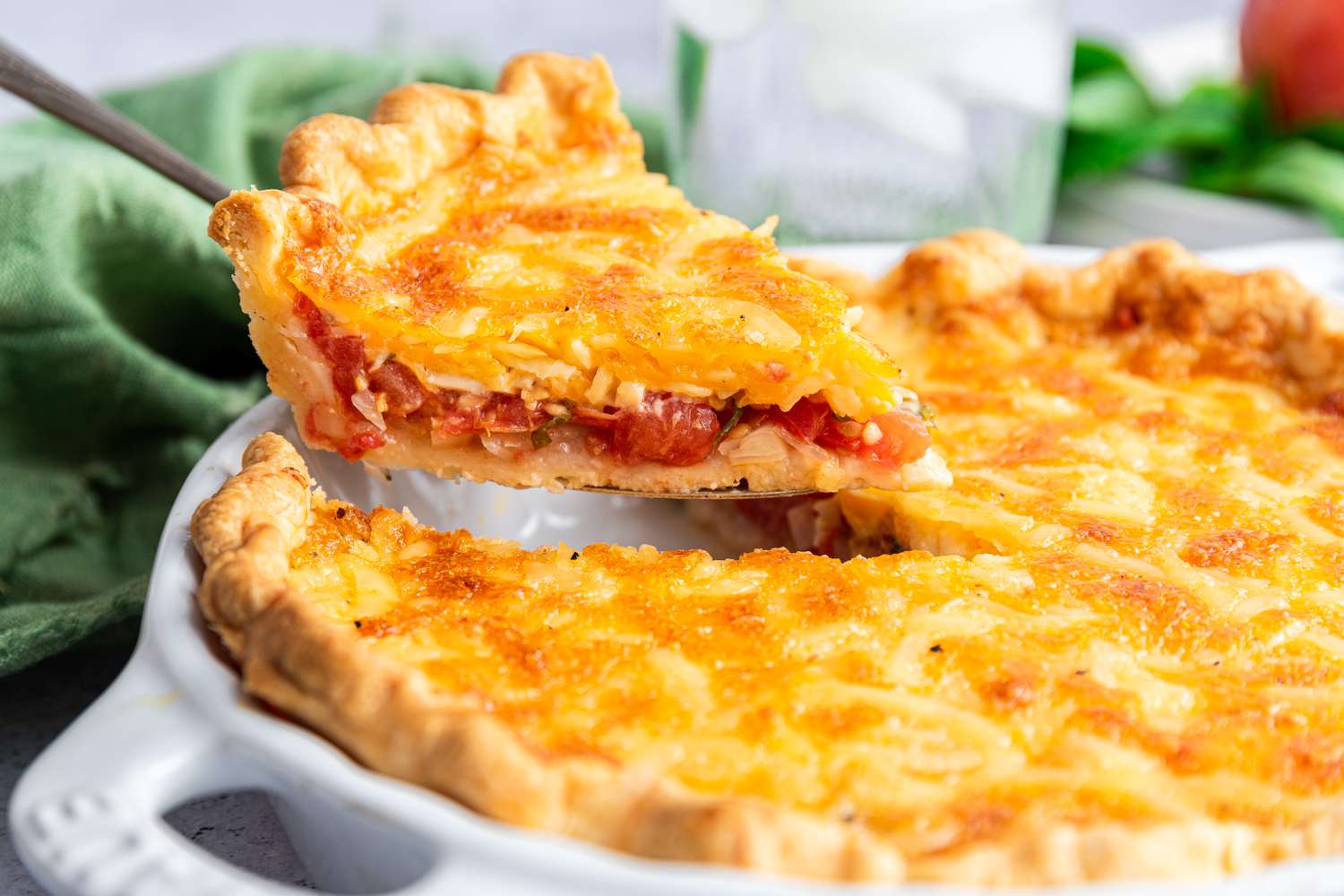 Tomato Pie with a Slice Lifted on a Pie Knife