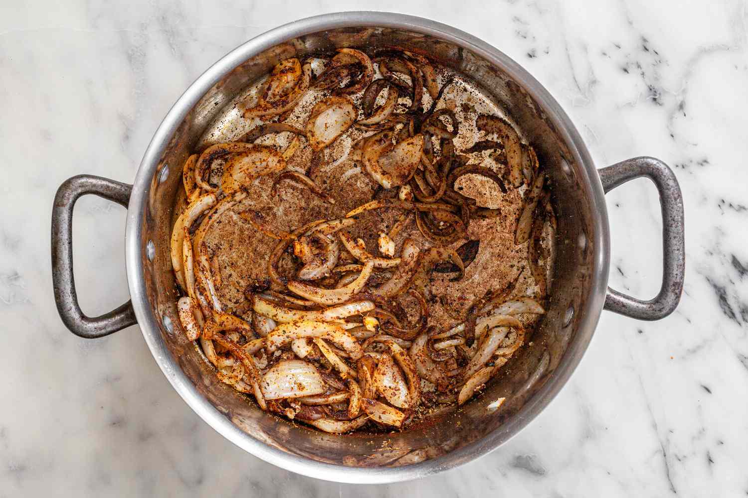 Spices Added to Cooked Onions for Creamy Chicken Enchilada Soup Recipe