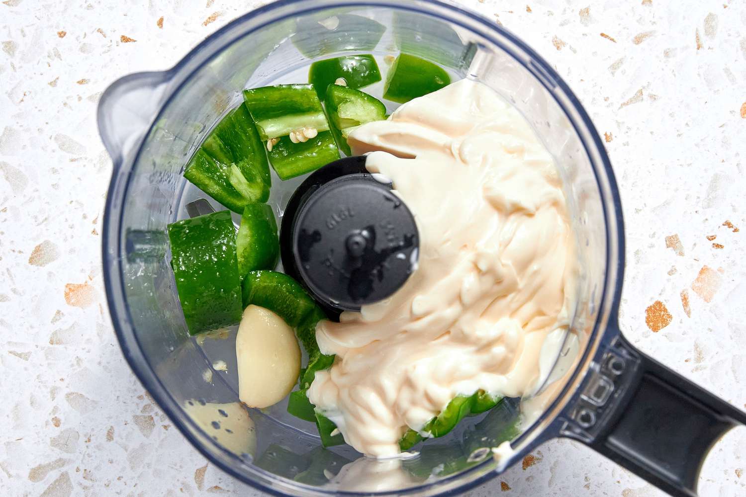 Spicy Mayo Ingredients (Mayonnaise, Jalapenos, and Garlic) in a Food Processor for Spicy Mayo Recipe
