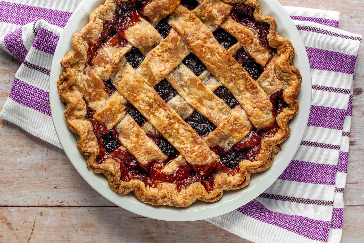 Blackberry Pie in a Pie Dish Sitting on a Kitchen Towel