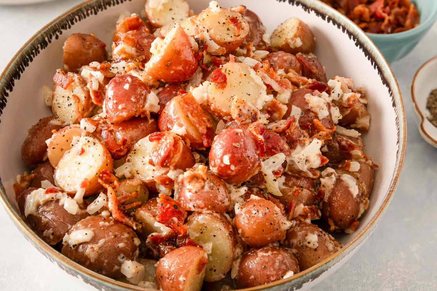 Bowl of potato salad with bacon and dressing