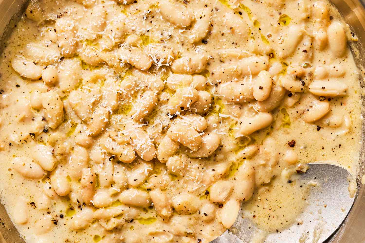 Cacio e pepe white beans with grated cheese on top