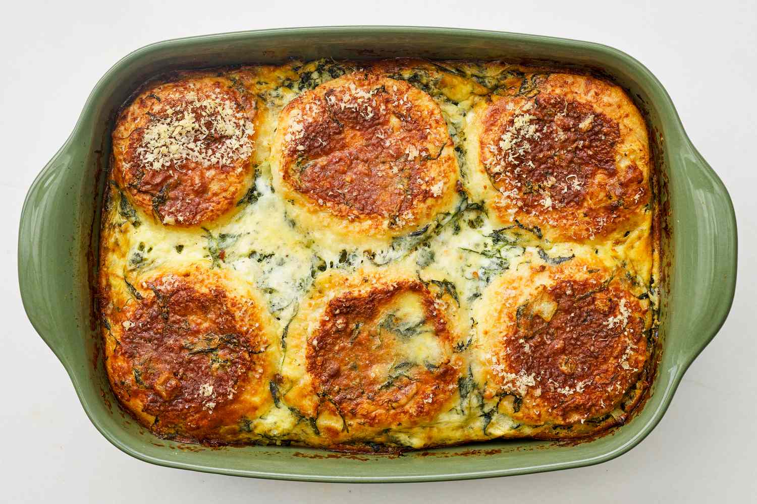 Baked spinach florentine breakfast casserole in a casserole dish 