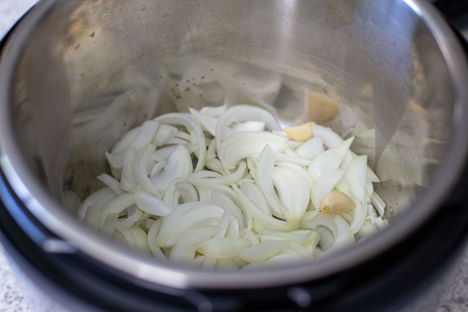 Sliced onions in an instant pot to make quick and easy instant pot turkey breasts