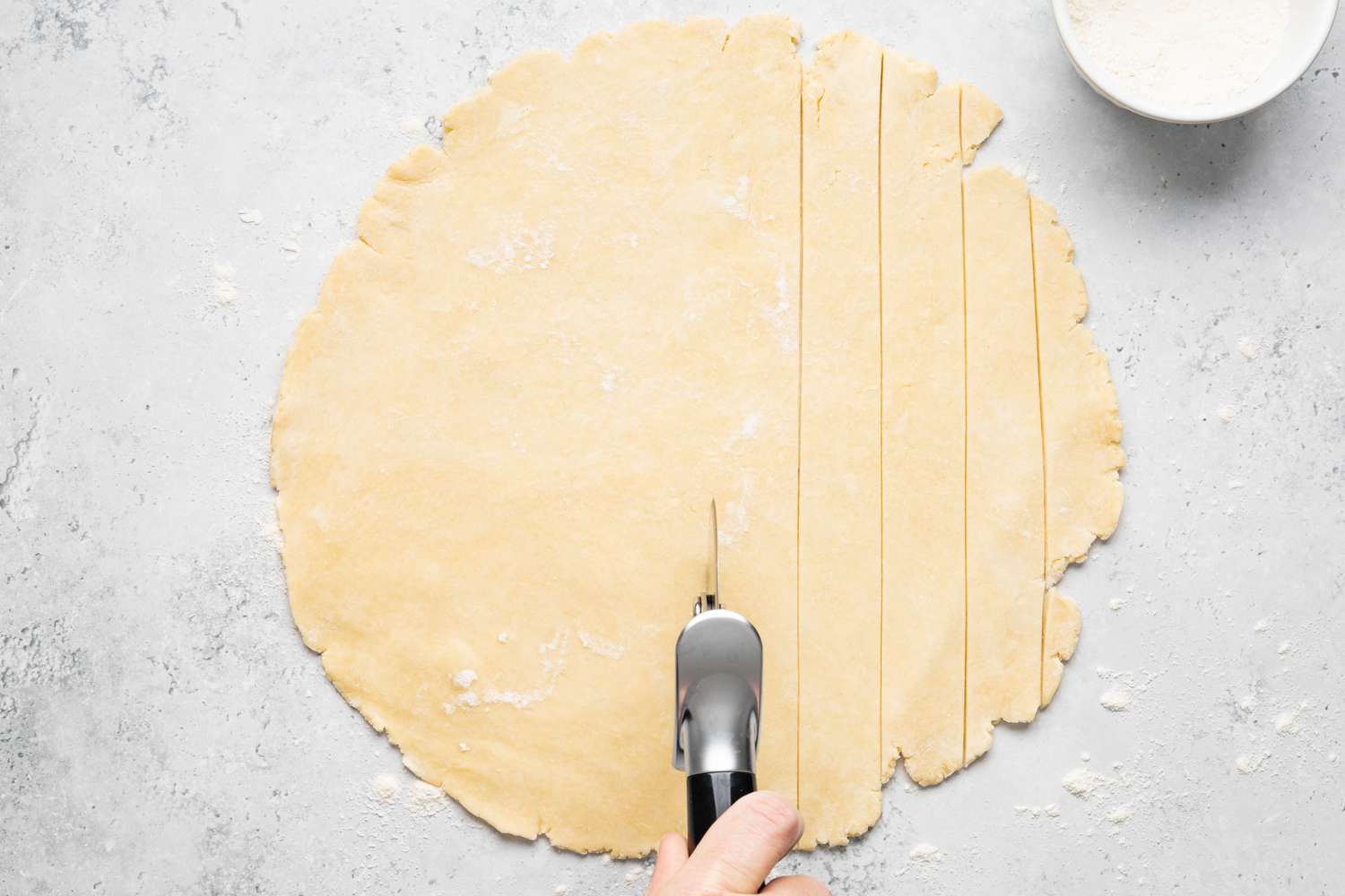Pie Dough Cut into Strips Using Pizza Roller to Make Lattice for Rhubarb Pie