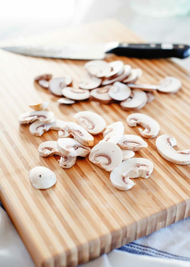 Sliced mushrooms on cutting board
