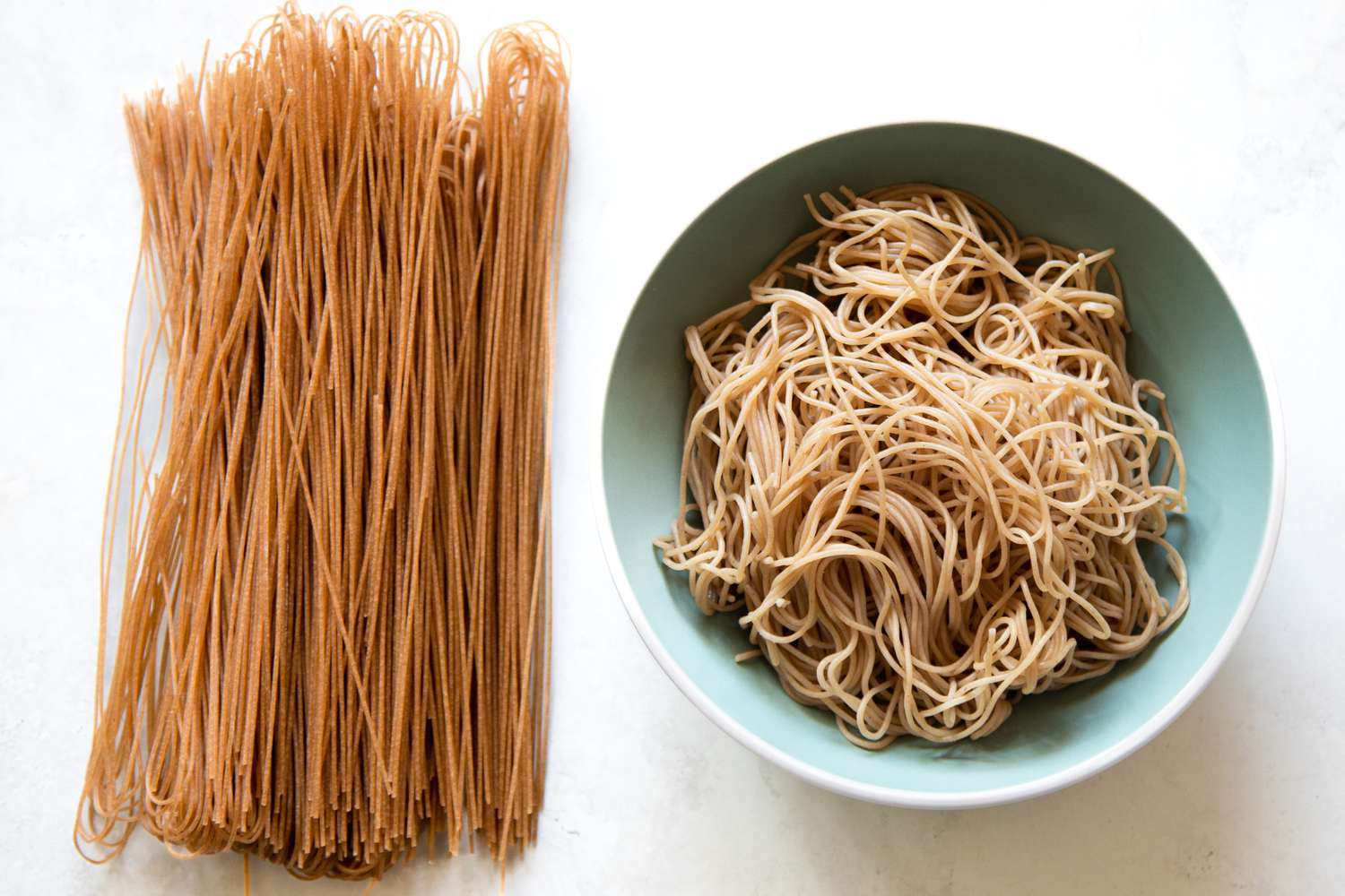 Dried Buckwheat Noodles (Naengmyeon Noodles) on the Left and Cooked Buckwheat Noodles in a Bowl on the Right