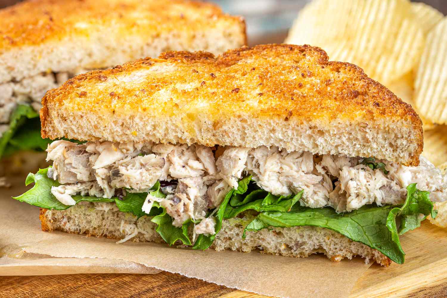 A photo of a tuna salad sandwich with lettuce