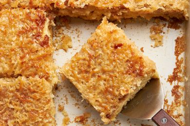 Lazy daisy cake slice on a spatula in a pan with more cake