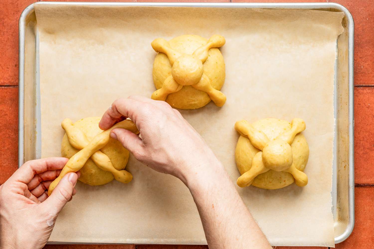 Bones placed on each dough ball in an X pattern and topped with the skull (placed where bones meet)