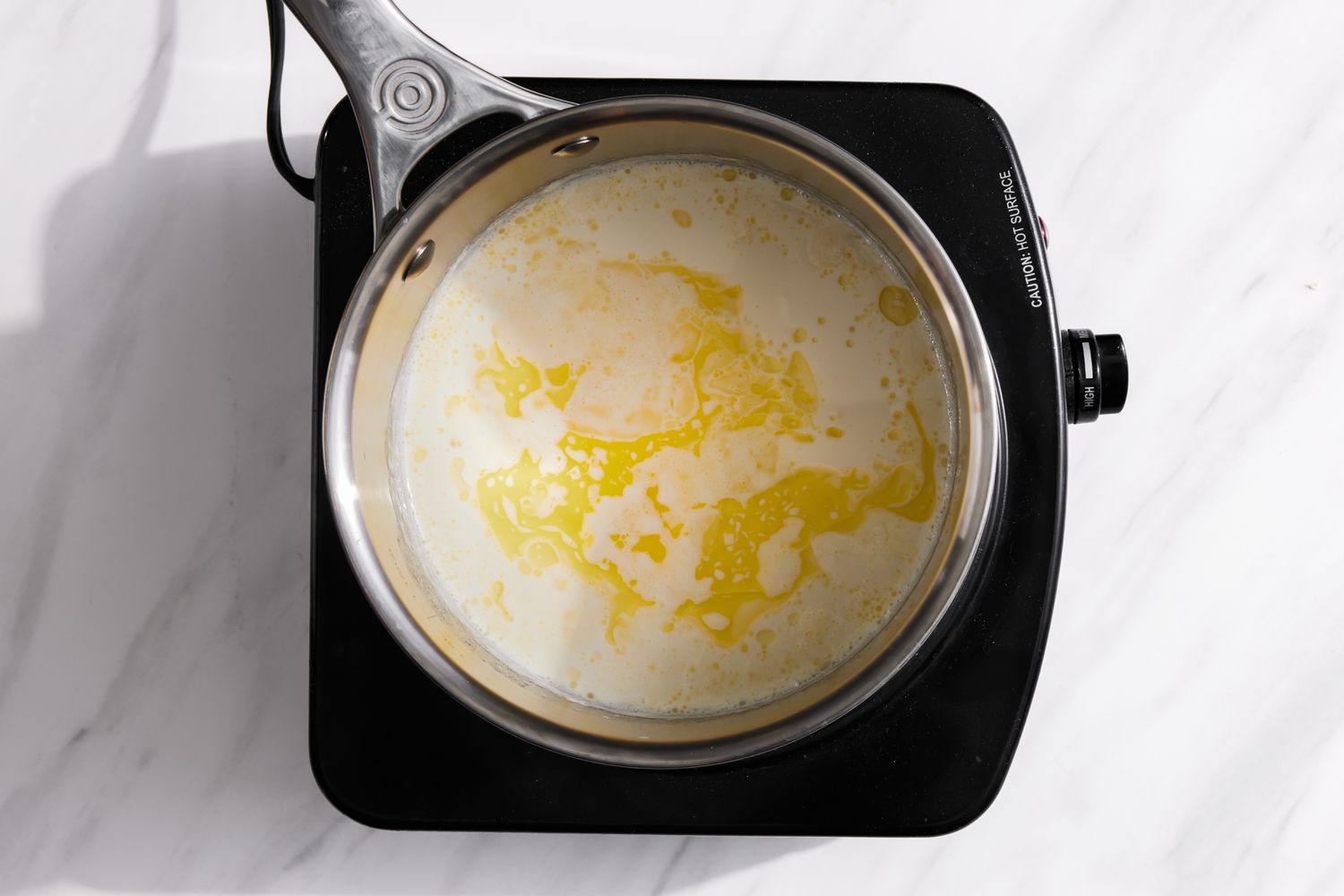 Heavy Cream and Butter in a Sauce Pan on a Portable Induction Burner for Peppermint Caramel Squares