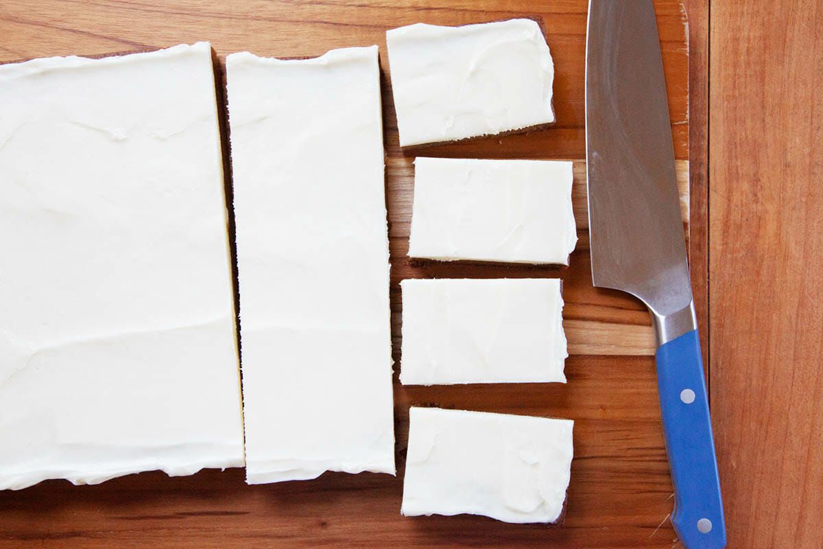 A knife cutting the Holiday Gingerbread Bars into squares.