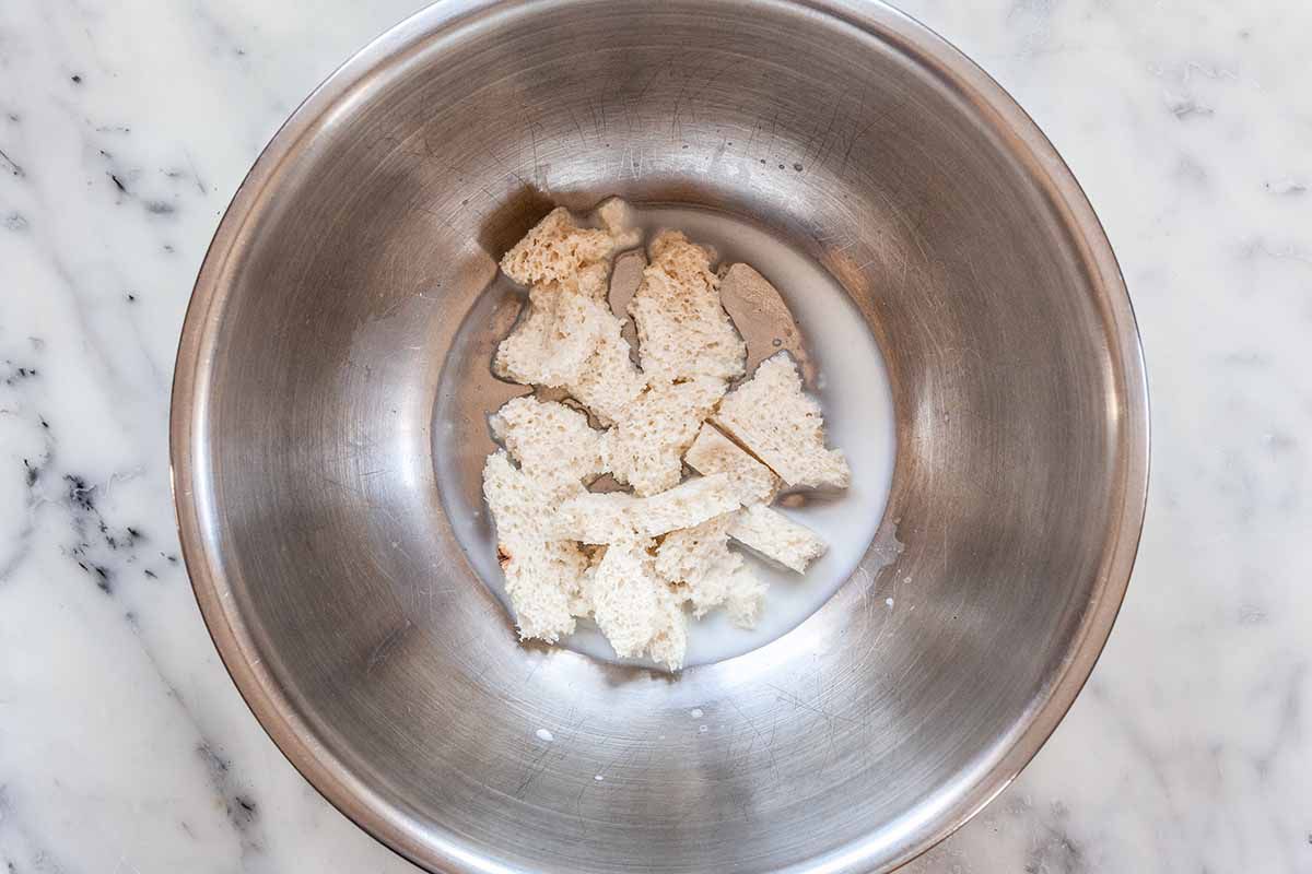 Ground beef and pork sausage meatball recipe - sliver bowl with torn bread