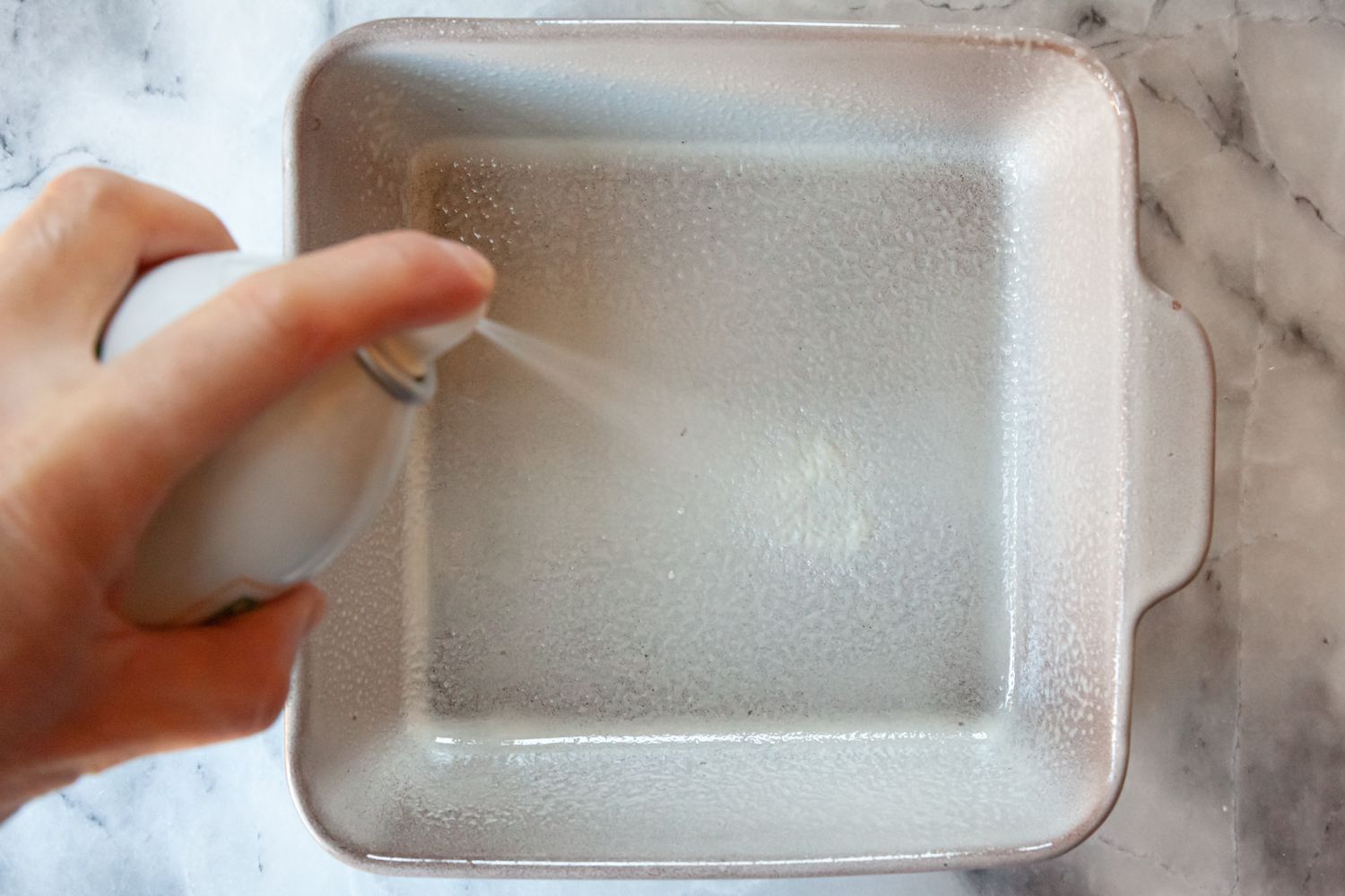 Spray Oil on Baking Pan for Rainbow Rice Krispie Treats