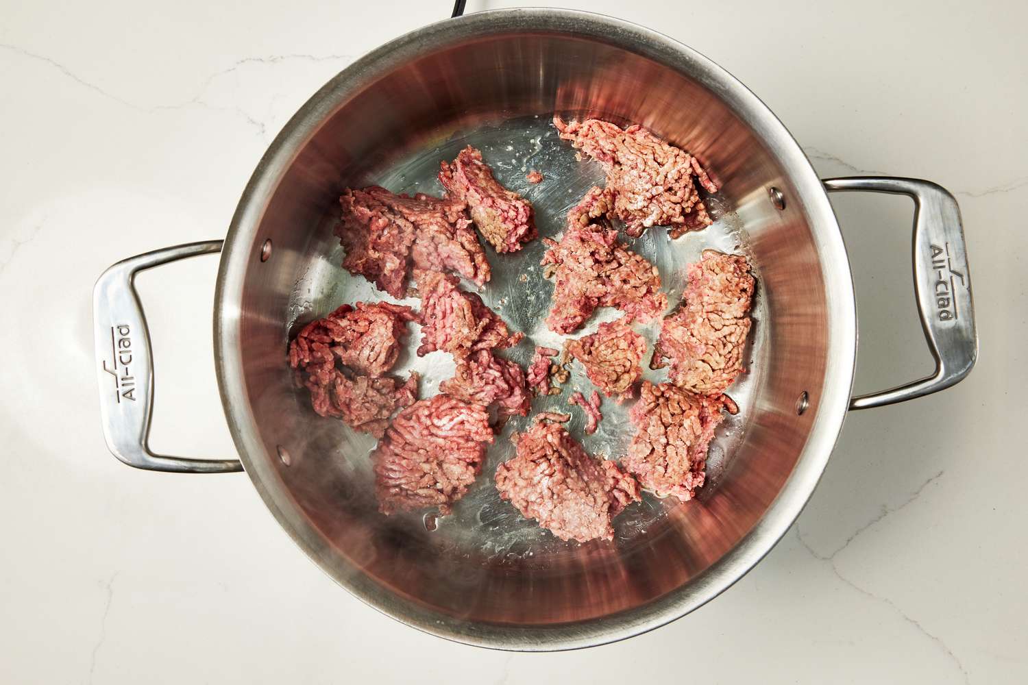 Browning ground beef in a pot for copycat Wendy's chili recipe