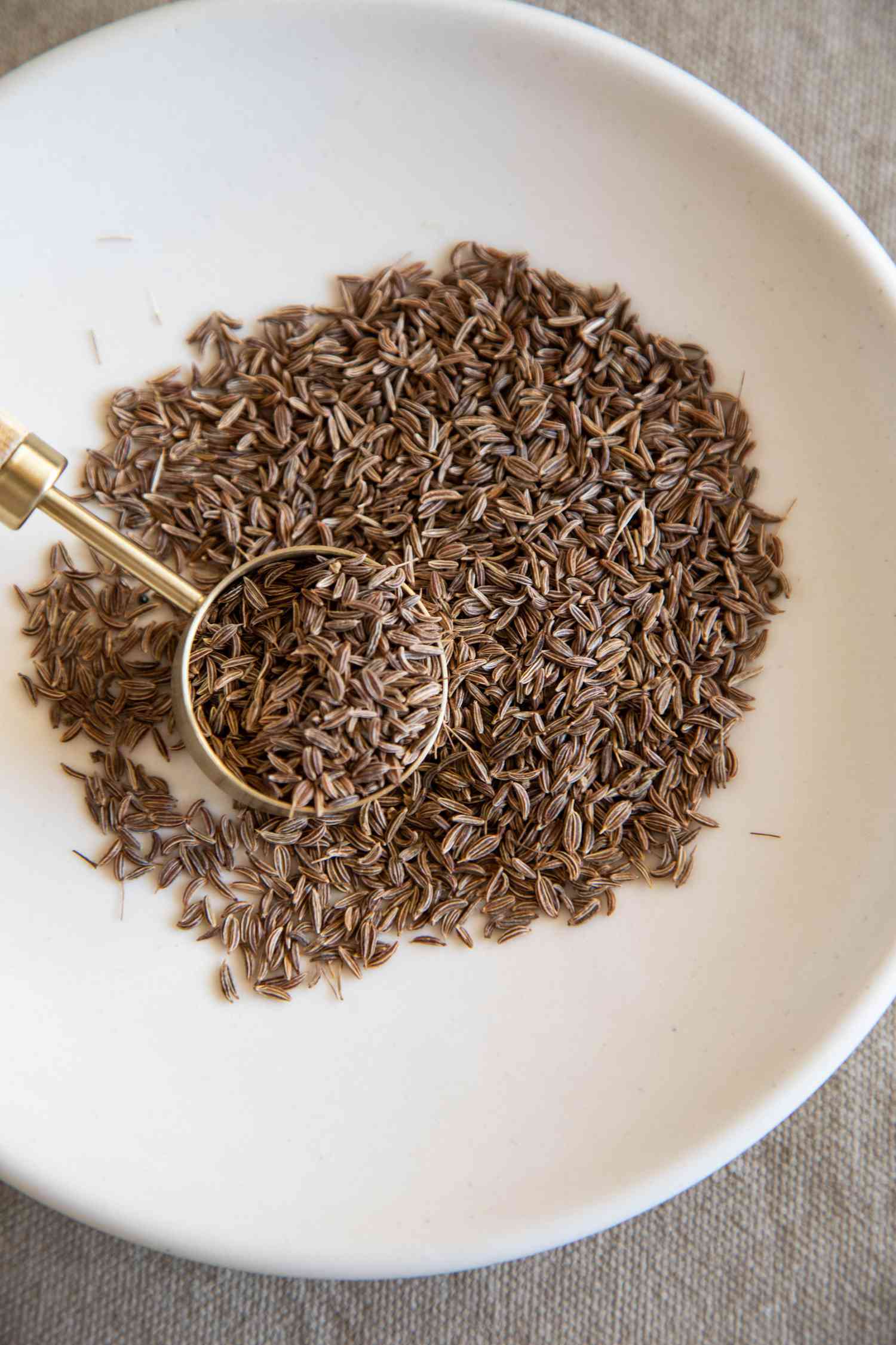 Caraway seeds in a white bowl