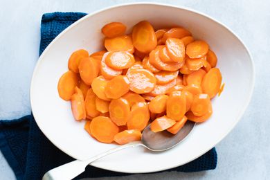 Overhead view of a serving bowl of glazed carrots.