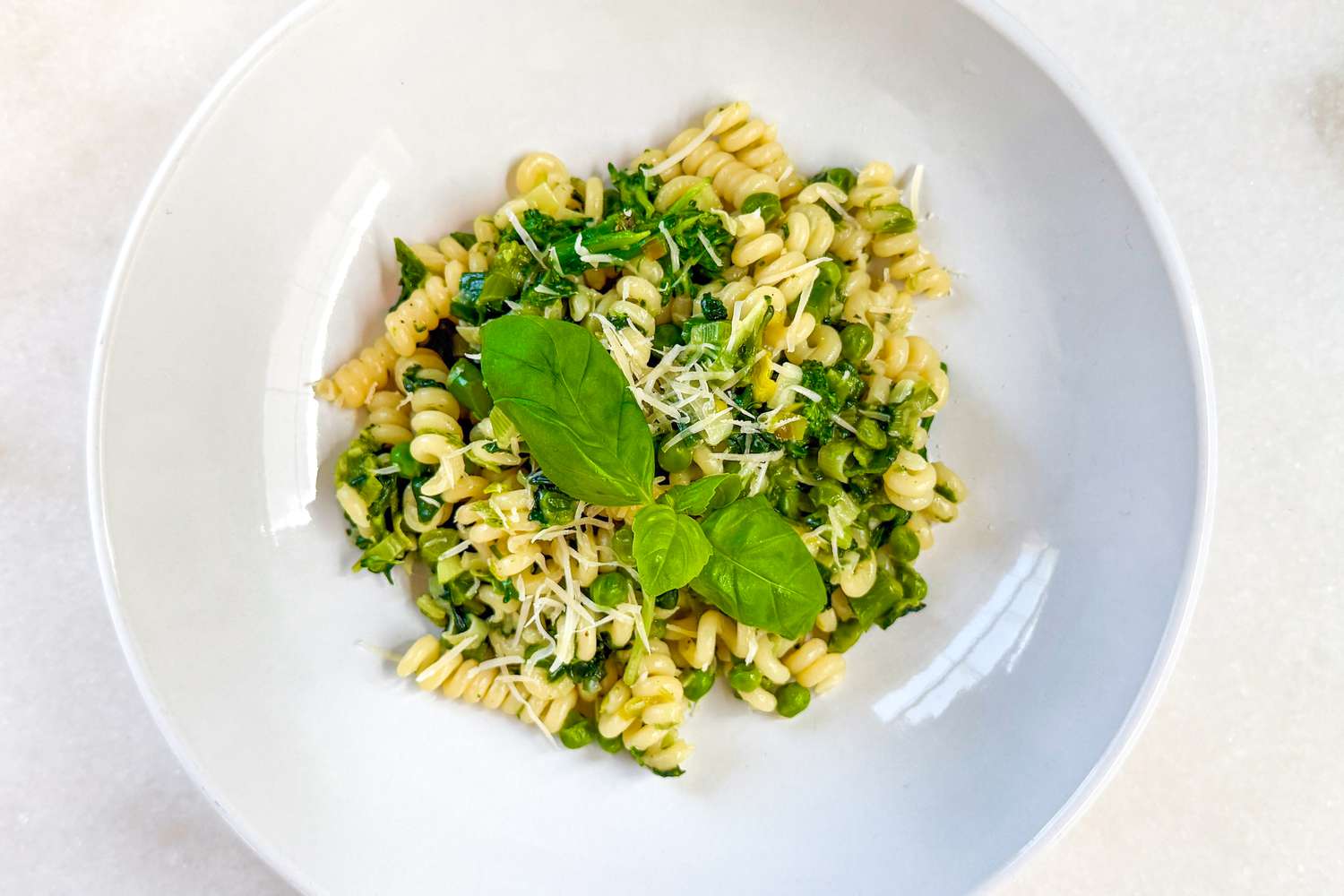 Overhead shot of a plate with a serving of Jamie Oliver's green pasta recipe