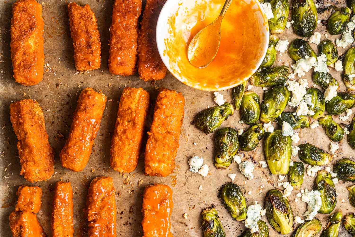 Sheet Pan Buffalo Tofu and Blue Cheese Brussels Sprouts on a Baking Sheet