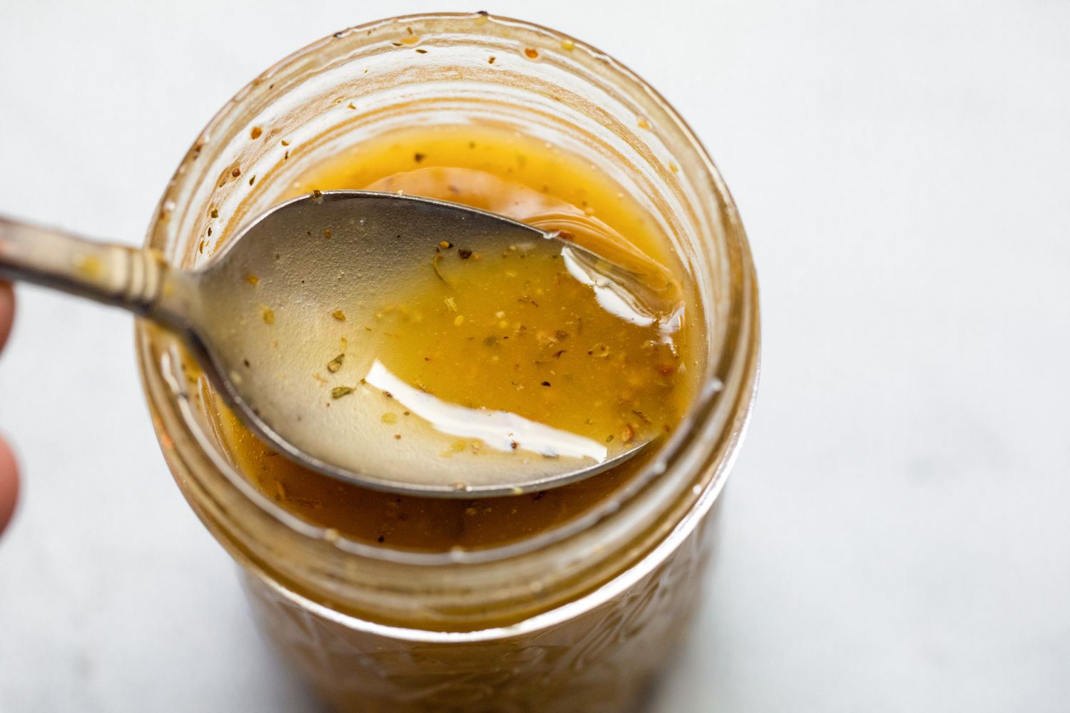 Salad Dressing Spooned from Jar for Italian Chopped Salad Recipe