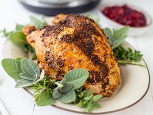 Quick and easy instant pot turkey breasts set on an herb covered platter.