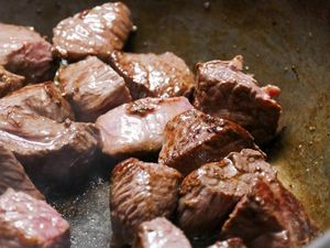 Cooking beef cubes in a pan