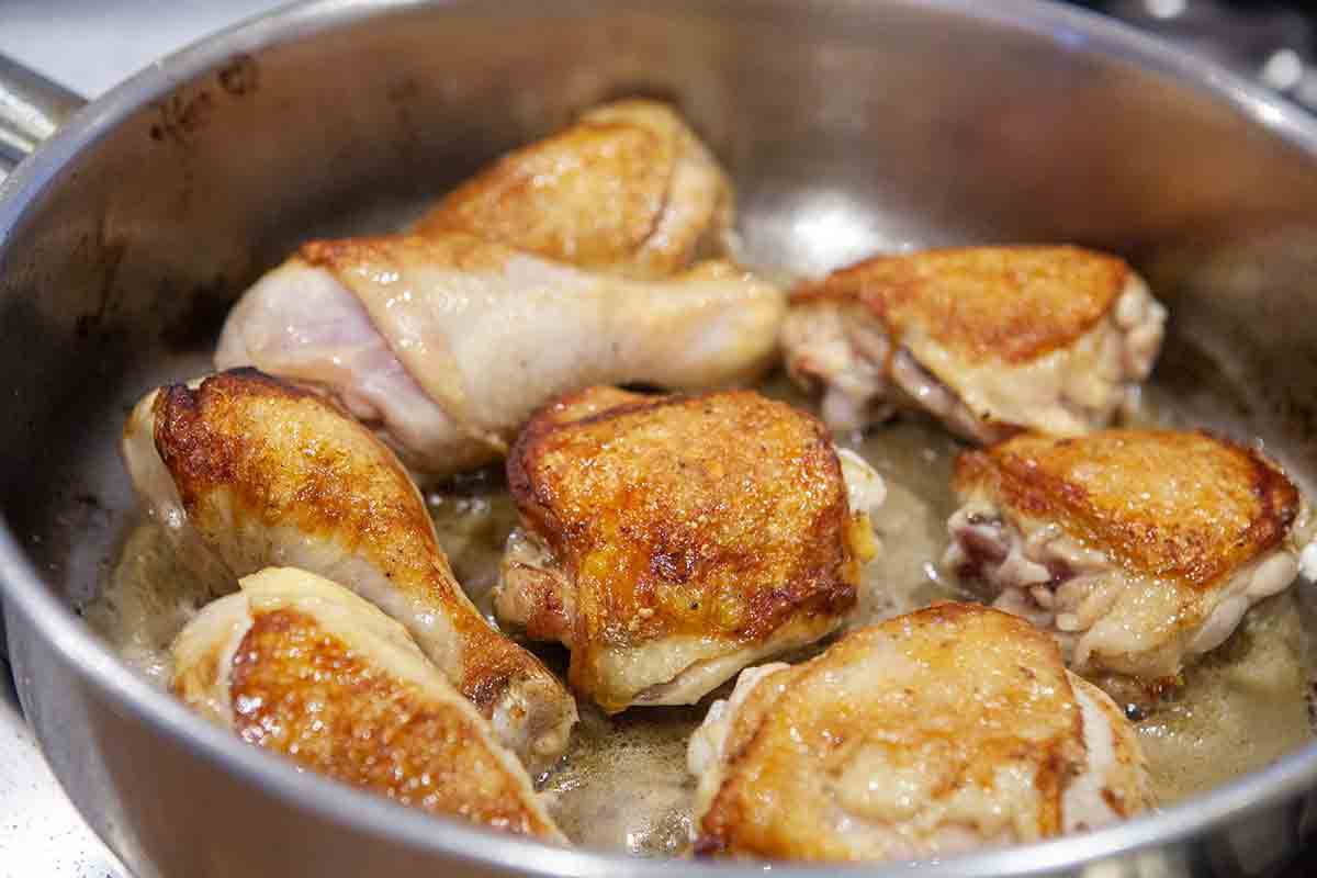 browned chicken pieces in pan