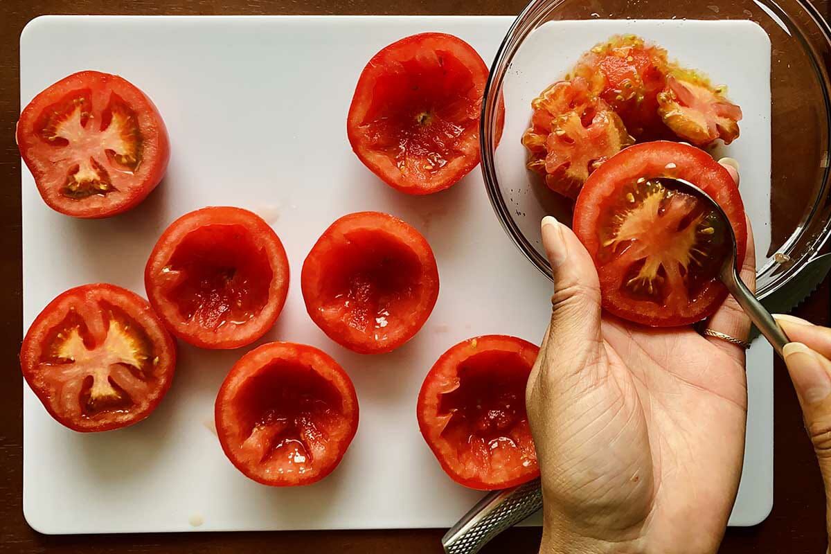 How to make stuffed tomatoes by removing the core and seeds of a halved tomato.