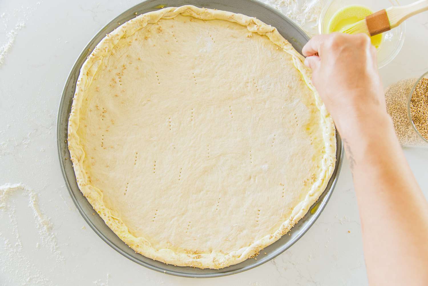 Cheeseburger Pizza Crust Edges Slightly Folded in and Topped with Sesame Seeds 