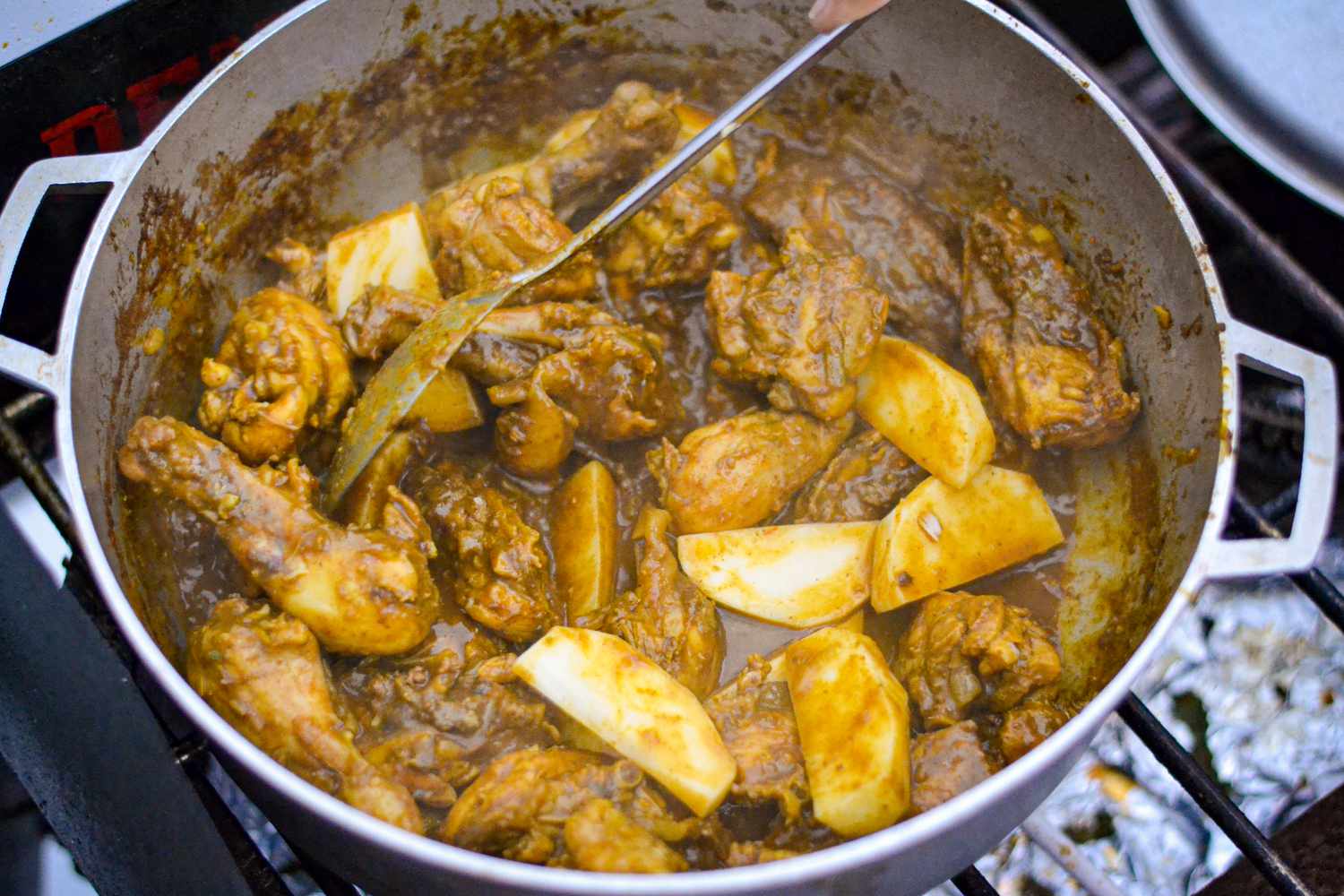 Potatoes Added to Chicken Curry in Pot