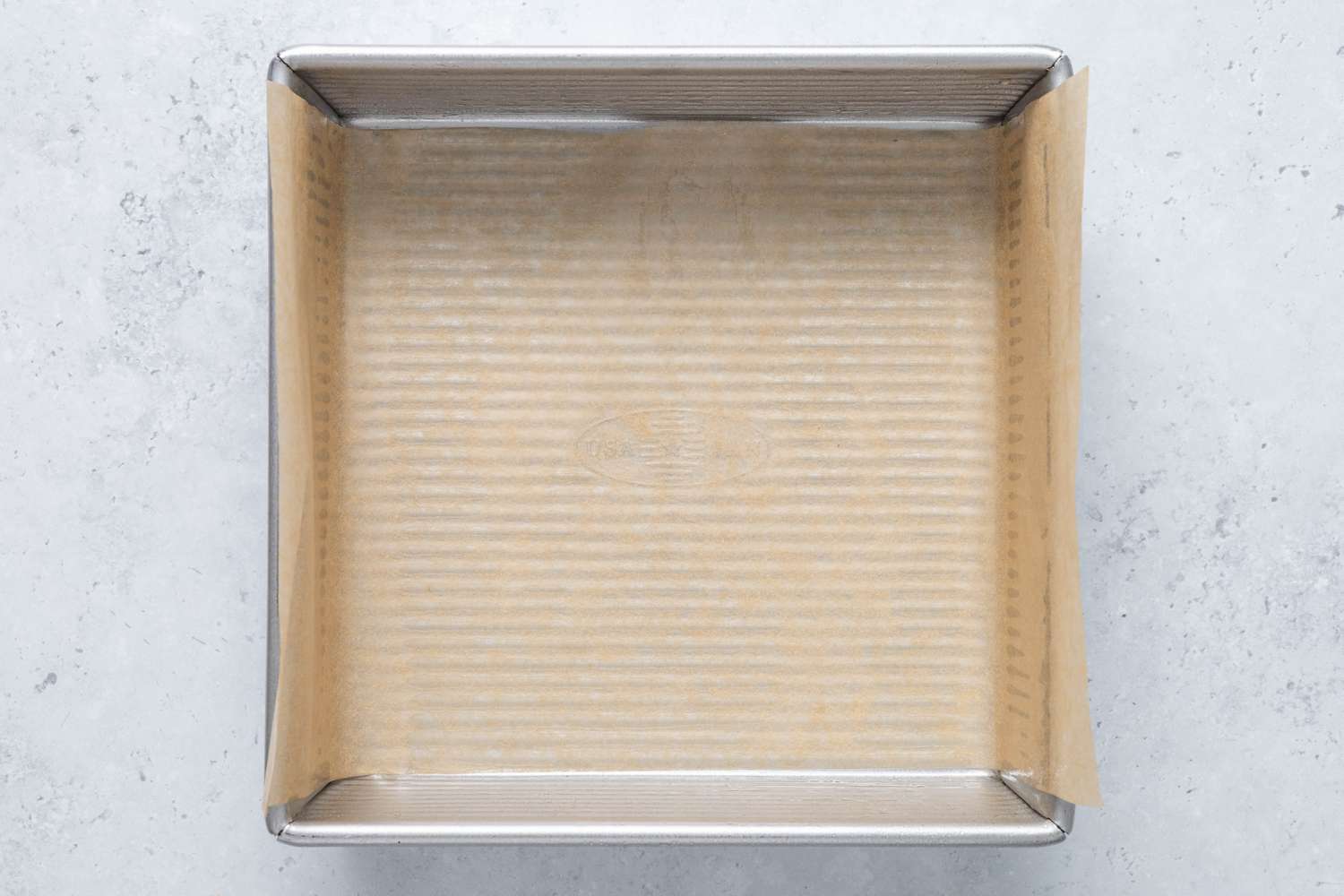 Parchment paper lined baking sheet for homemade Cosmic Brownies recipe