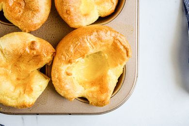 Close up of a yorkshire pudding in a muffin tin.