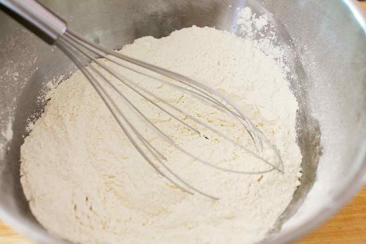 using a whisk to mix dry cake ingredients