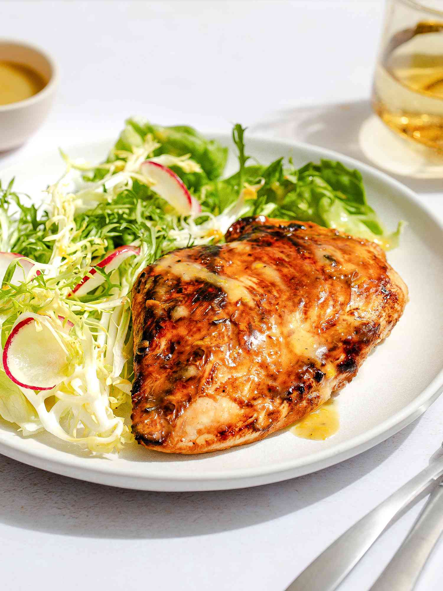 Honey mustard chicken on a plate with a side salad